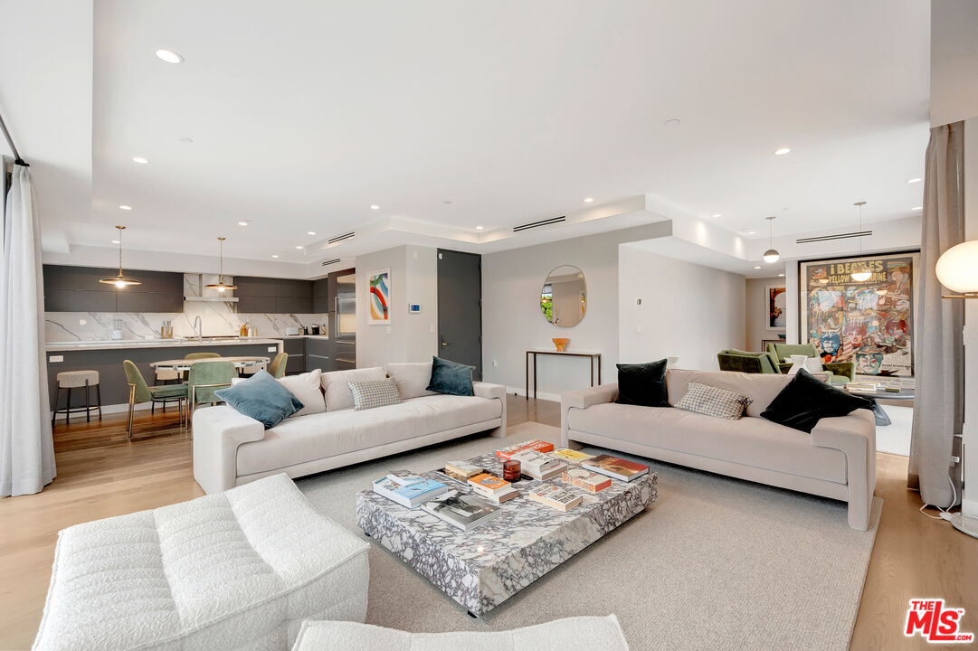 1017 North Croft Avenue, Unit PH1 Los Angeles, CA 90069 - Photo 9 of 34 a living room with furniture kitchen view and a table
