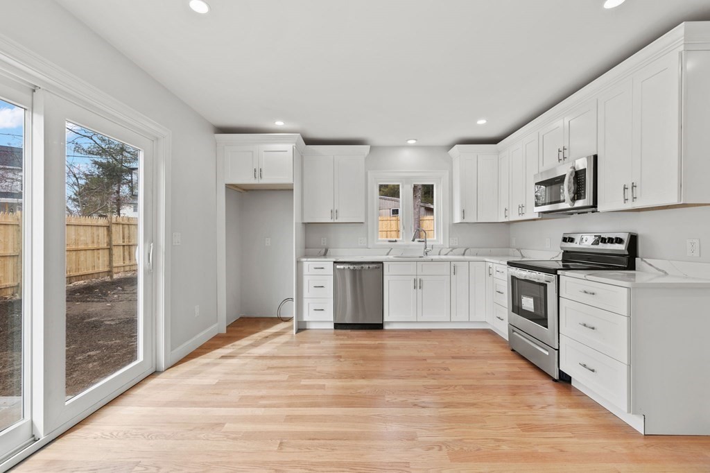 180 Barker Road East Wareham, MA 02538 - Photo 23 of 29 a kitchen with granite countertop white cabinets and stainless steel appliances