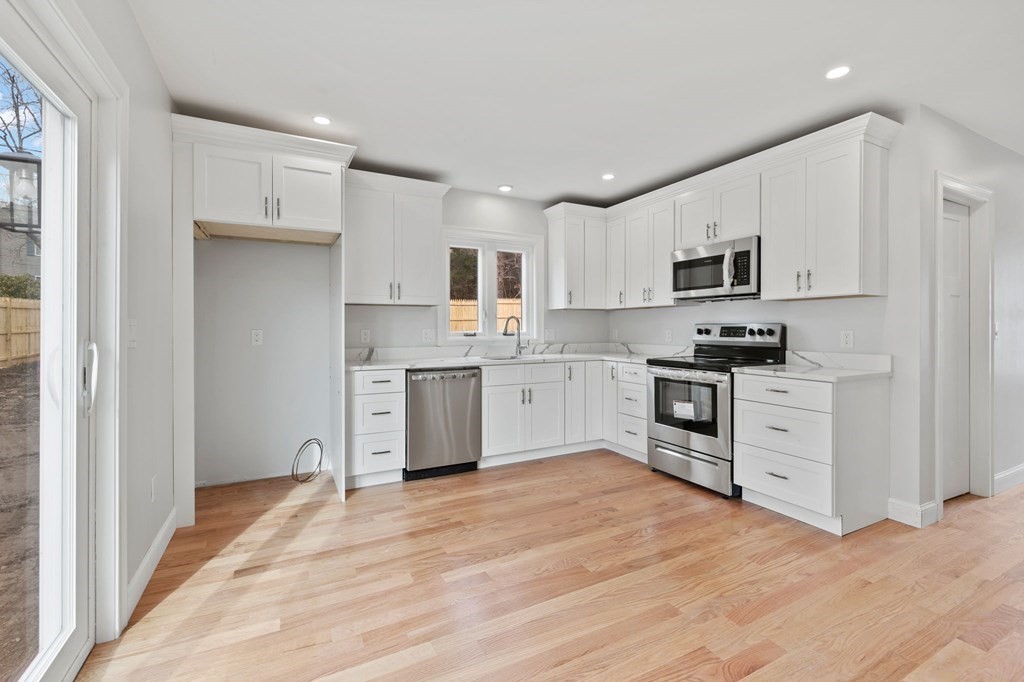 180 Barker Road East Wareham, MA 02538 - Photo 24 of 29 a kitchen with white cabinets stainless steel appliances and a window