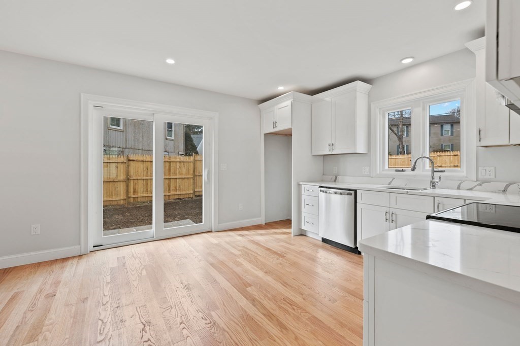 180 Barker Road East Wareham, MA 02538 - Photo 25 of 29 a large white kitchen with stainless steel appliances granite countertop a stove a sink and white cabinets