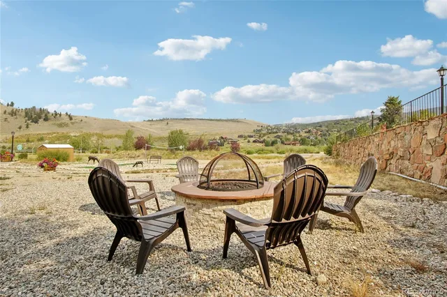 a view of a swimming pool with an outdoor seating and a lake view