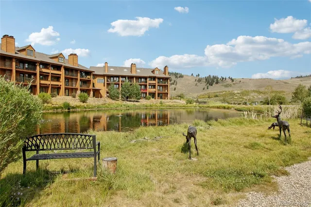 a swimming pool with outdoor seating and city view