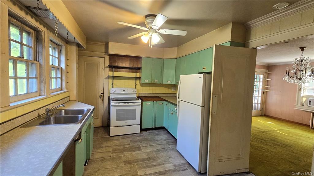 17 Old Mill Road Poughkeepsie, NY 12603 - Photo 14 of 23 a kitchen with a refrigerator a stove top oven a sink and dishwasher