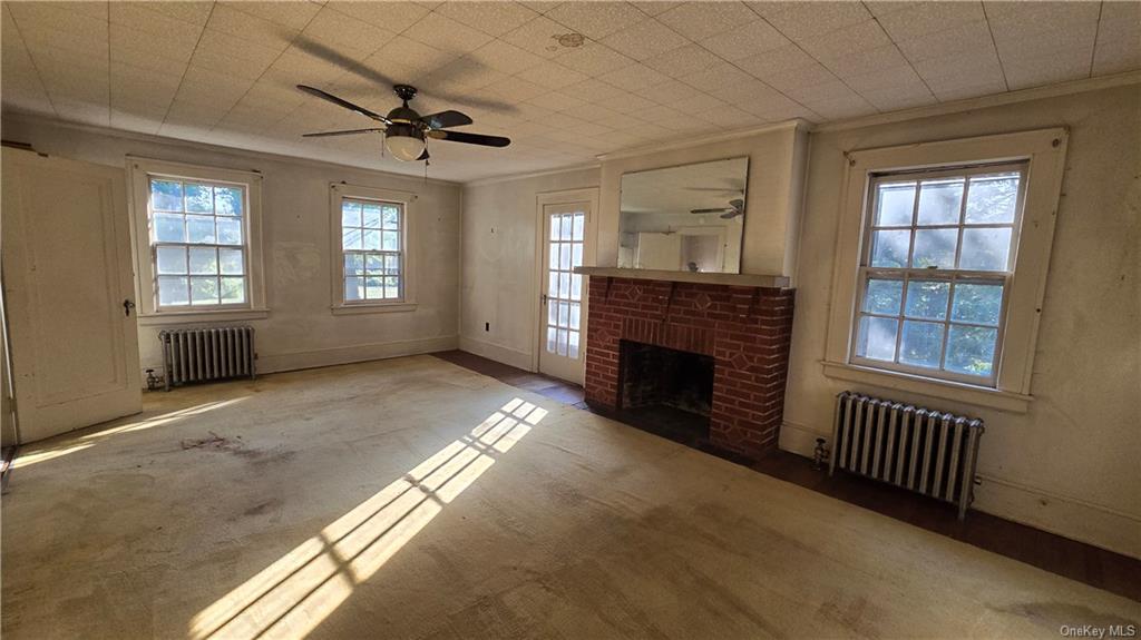 17 Old Mill Road Poughkeepsie, NY 12603 - Photo 17 of 23 a view of an empty room with a fireplace and a window