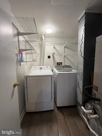 a large kitchen with stainless steel appliances granite countertop a stove refrigerator and cabinets