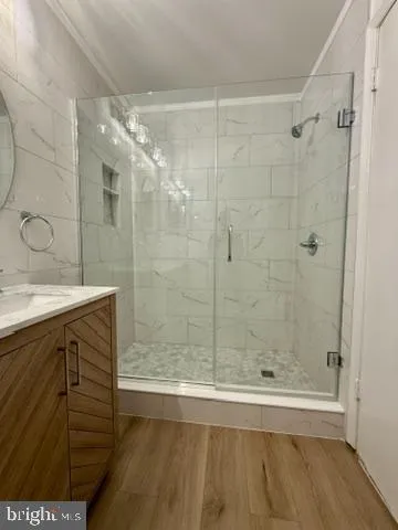 a bathroom with a double vanity sink toilet and shower