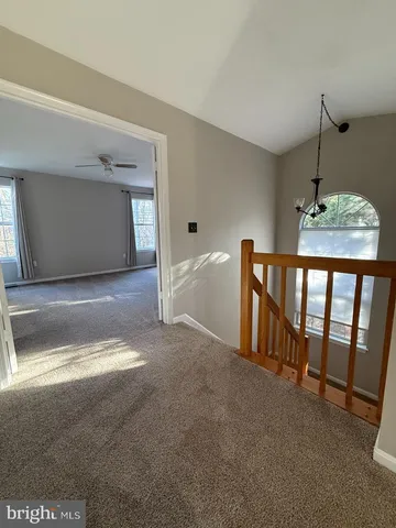 a view of empty room with a fireplace and wooden floor