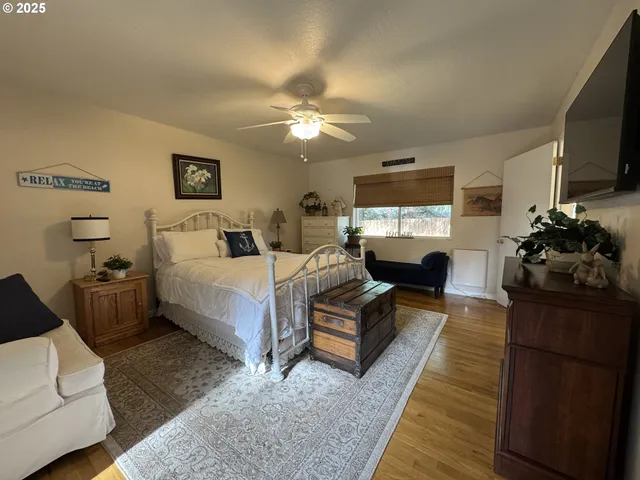 a bedroom with a bed and a television