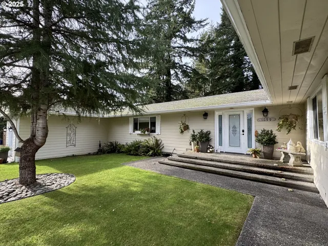 a view of a house with a yard patio and a small yard