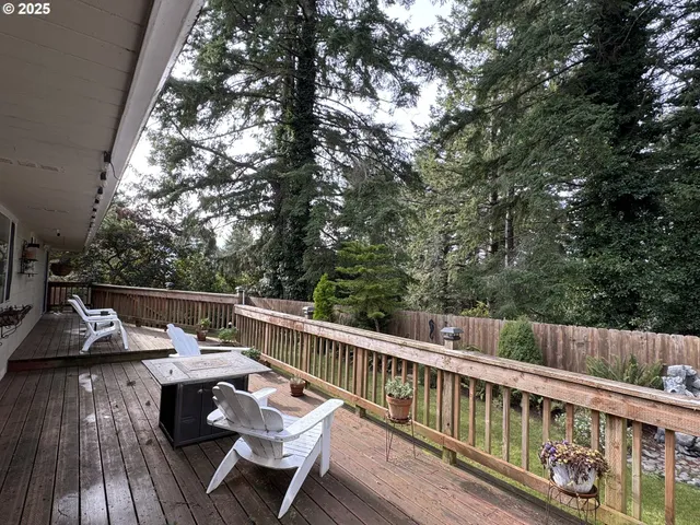 a balcony with wooden floor and outdoor seating