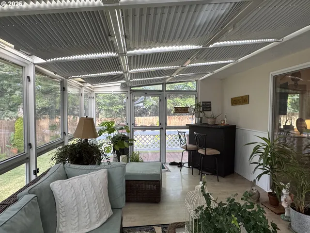 a view of a house with backyard and sitting area