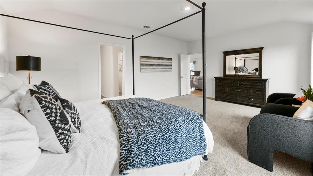 1671 Mantle Road Crandall, TX 75114 - Photo 13 of 24 Spacious bedroom featuring light-colored carpeting, white walls, and an open doorway revealing an interior hallway