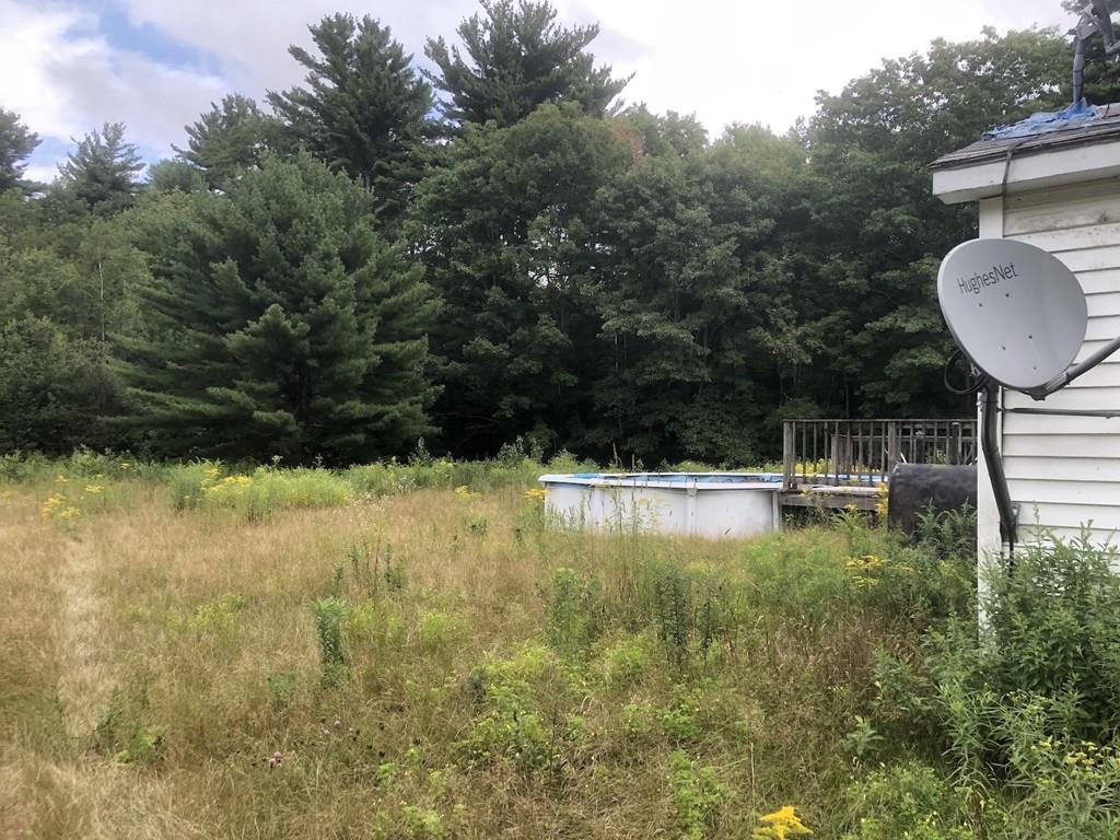 800 Washburn Road Barre, MA 01005 - Photo 7 of 15 a view of a swimming pool with a patio and a yard