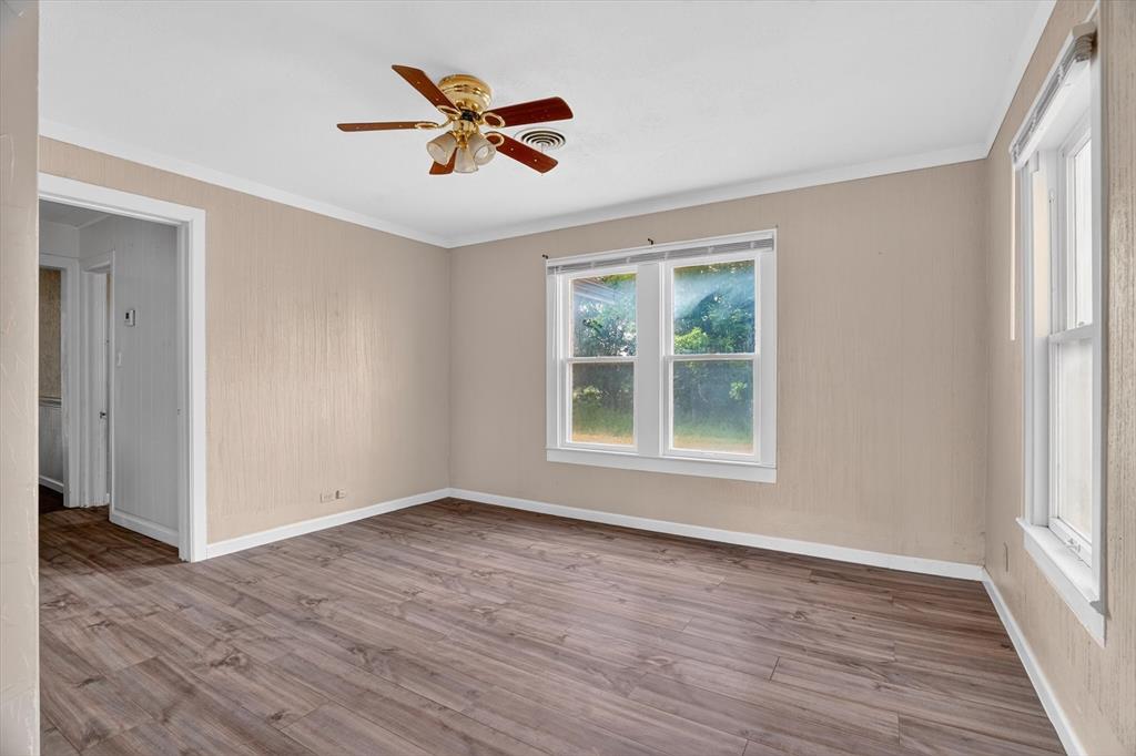 320 North 2nd Street Jacksboro, TX 76458 - Photo 12 of 16 wooden floor in an empty room with a window