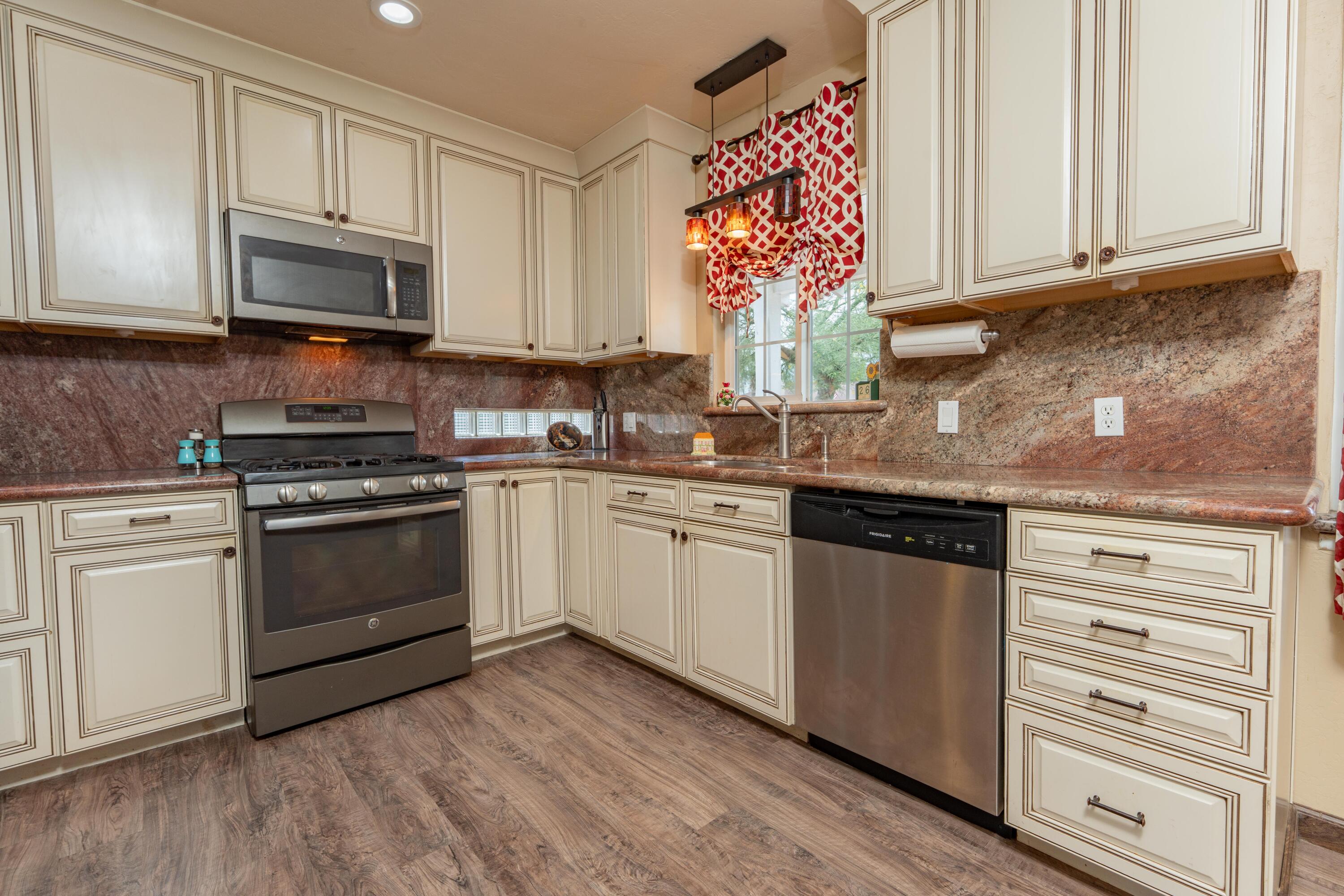 570 North Birch Avenue Reedley, CA 93654 - Photo 15 of 52 a kitchen with granite countertop a sink stainless steel appliances and cabinets