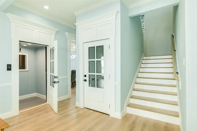 a view of a hallway with wooden floor and entryway