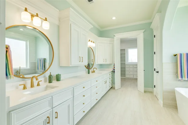 a spacious bathroom with a double vanity sink and a mirror