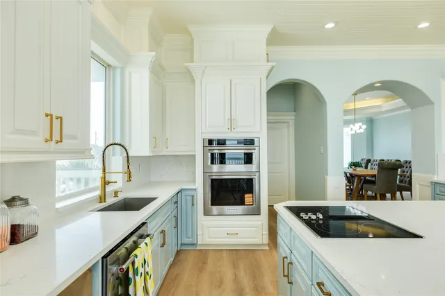 a kitchen with stainless steel appliances granite countertop a sink and cabinets