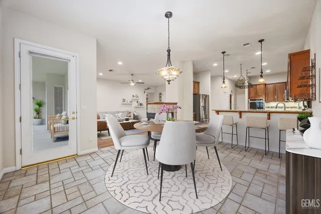 a spacious bedroom with a bed and a chandelier