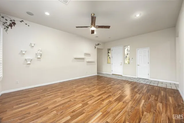 a view of an empty room with a fireplace and a window