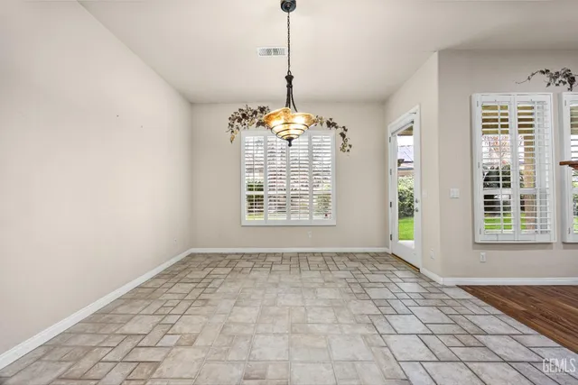 a kitchen with stainless steel appliances granite countertop a stove a sink dishwasher and a refrigerator