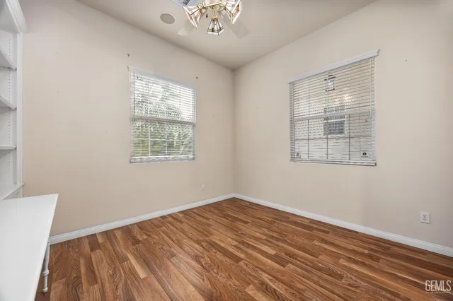 a spacious bathroom with a shower a sink and a large mirror
