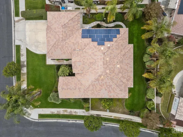 an aerial view of a house with yard