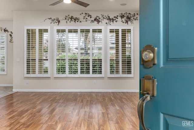 a view of a livingroom with wooden floor and a window