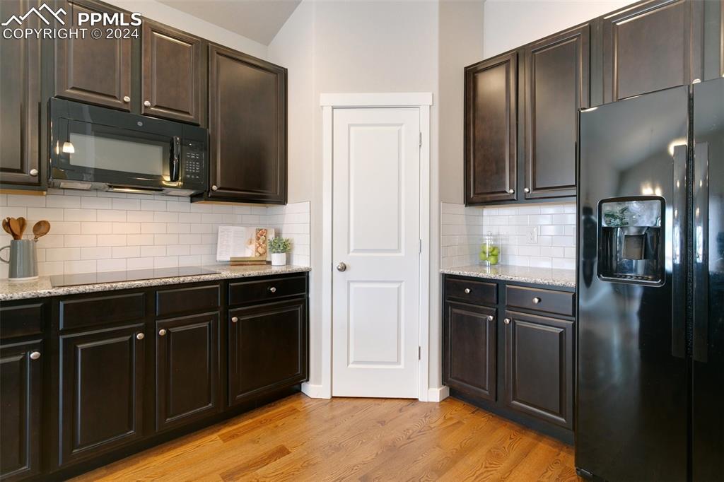 10110 Henman Terrace Peyton, CO 80831 - Photo 12 of 36 a kitchen with stainless steel appliances granite countertop a refrigerator stove and microwave