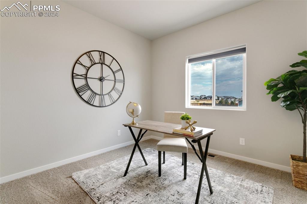 10110 Henman Terrace Peyton, CO 80831 - Photo 18 of 36 a work room with furniture and a window