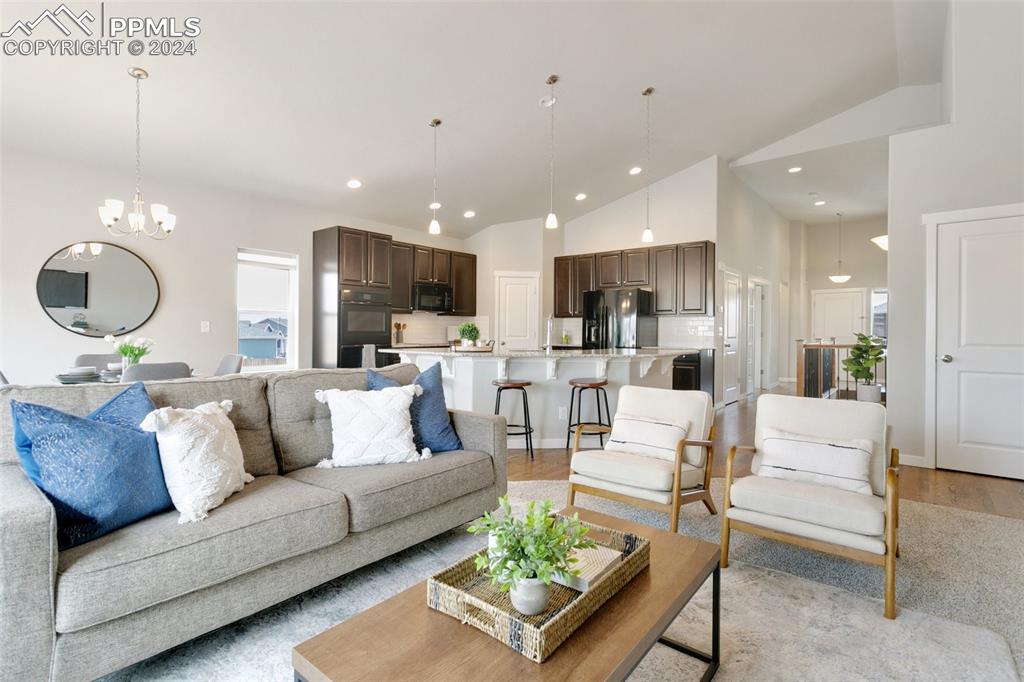 10110 Henman Terrace Peyton, CO 80831 - Photo 2 of 36 a living room with furniture and kitchen view