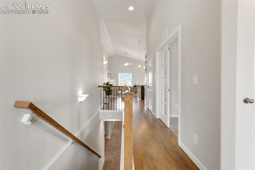 10110 Henman Terrace Peyton, CO 80831 - Photo 22 of 36 a view of a hallway with wooden floor and staircase