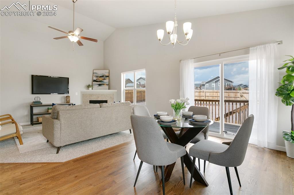 10110 Henman Terrace Peyton, CO 80831 - Photo 6 of 36 a dining room with furniture a chandelier and wooden floor