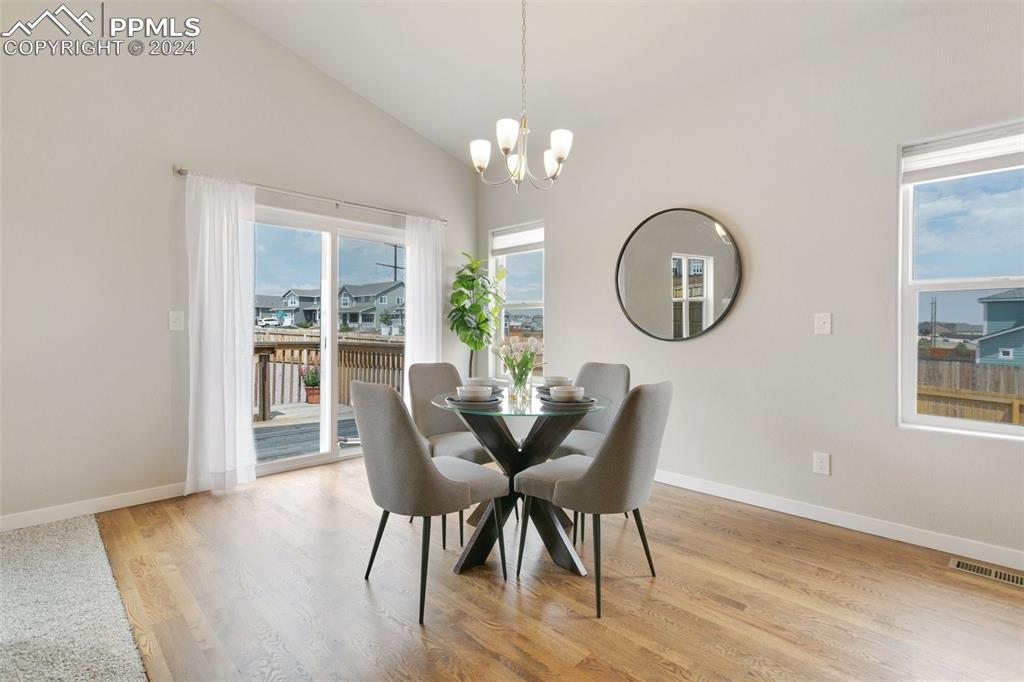 10110 Henman Terrace Peyton, CO 80831 - Photo 7 of 36 a view of a dining room with furniture and chandelier