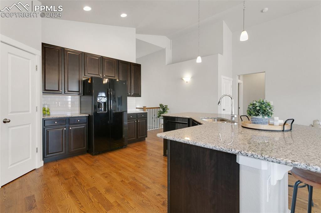 10110 Henman Terrace Peyton, CO 80831 - Photo 9 of 36 a kitchen with stainless steel appliances granite countertop a sink a stove and a refrigerator