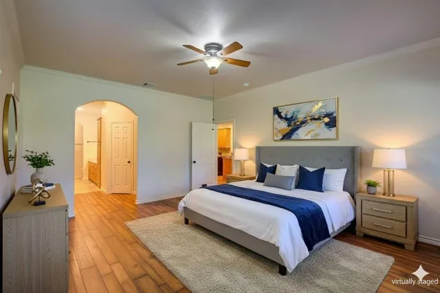 a bedroom with a bed and a chandelier