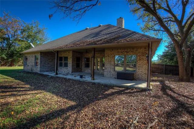 a view of a porch with wooden floor and a fireplace