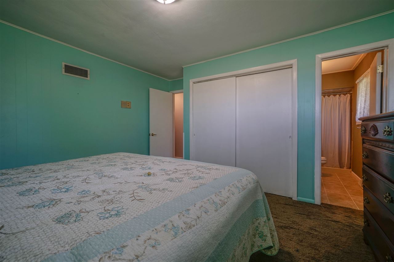 14588 Freeport Road Durand, IL 61024 - Photo 11 of 25 a bedroom with a bed and a flat tv screen on dresser