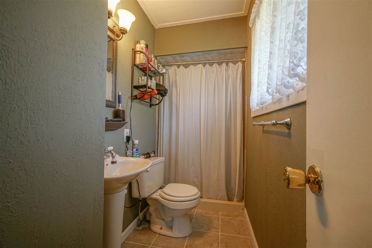 14588 Freeport Road Durand, IL 61024 - Photo 12 of 25 a bathroom with a toilet a sink and shower