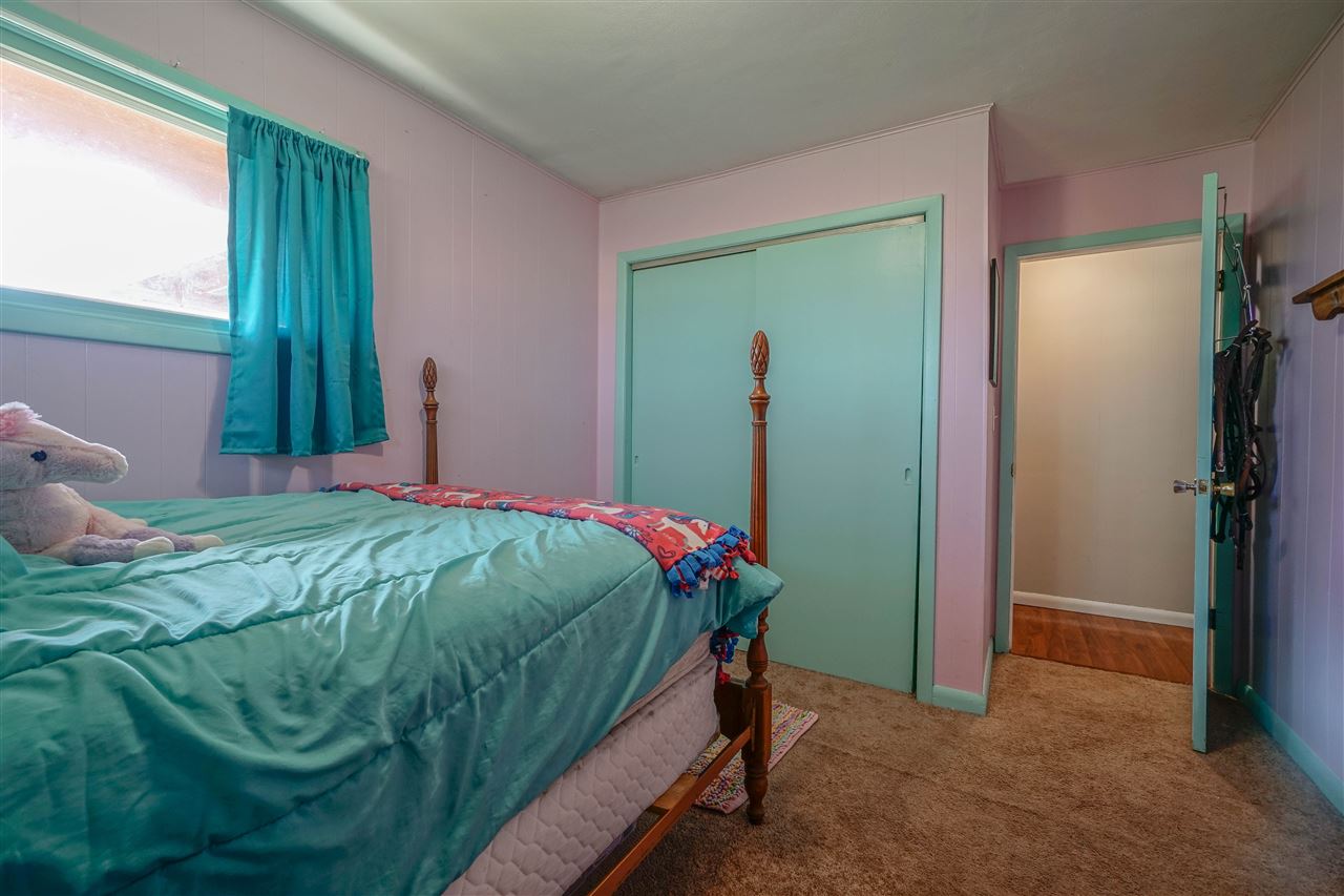 14588 Freeport Road Durand, IL 61024 - Photo 13 of 25 a bed sitting in a bedroom next to a window