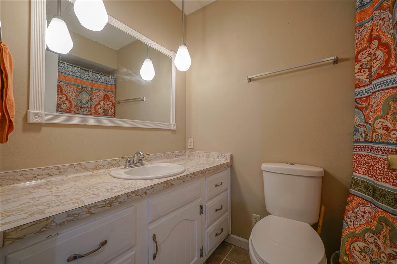 14588 Freeport Road Durand, IL 61024 - Photo 14 of 25 a bathroom with a granite countertop toilet sink and mirror