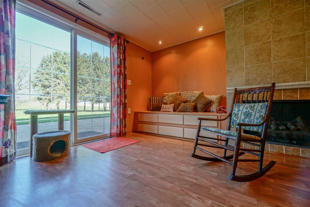 14588 Freeport Road Durand, IL 61024 - Photo 16 of 25 a living room with furniture a rug and a floor to ceiling window