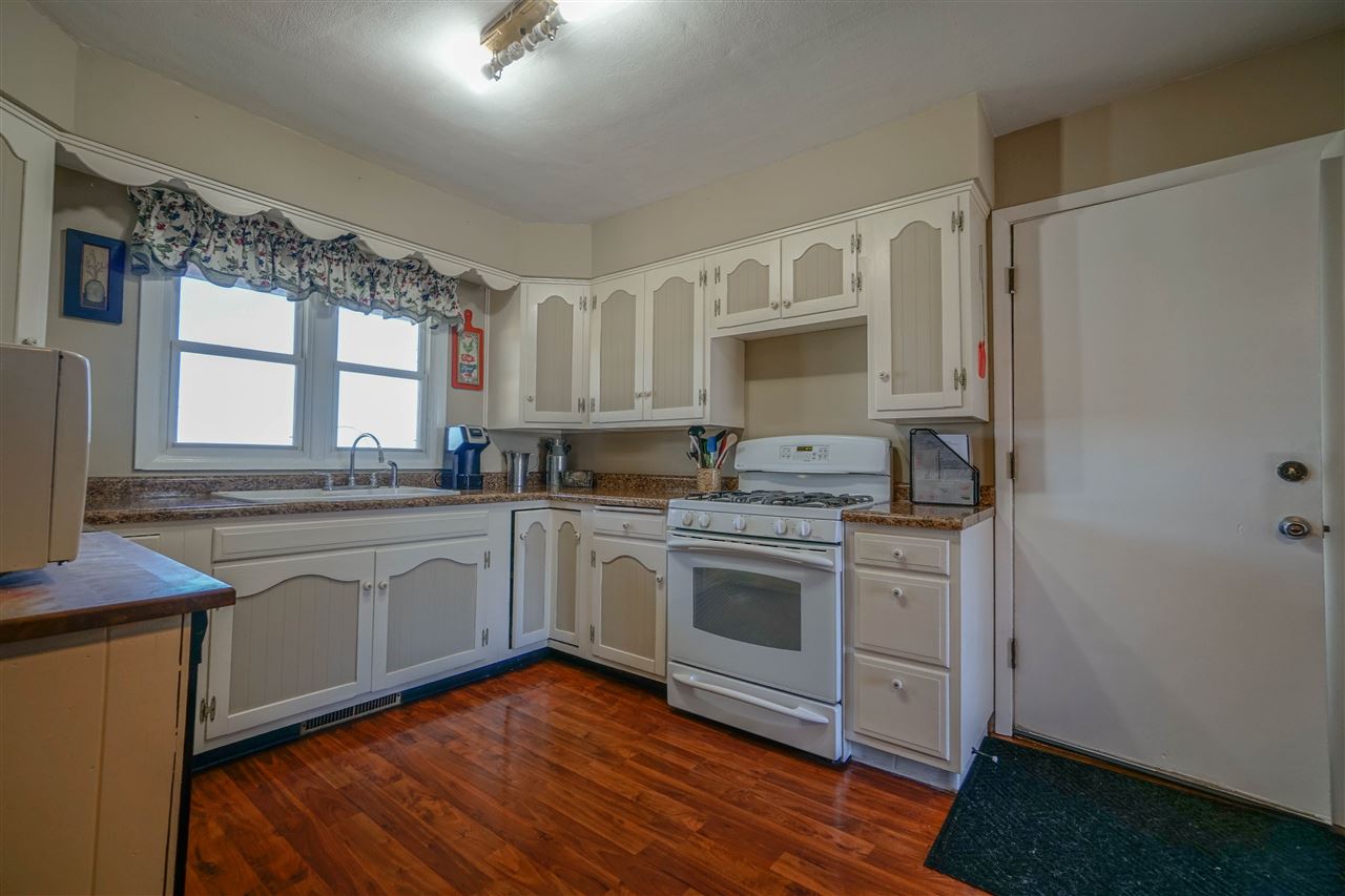 14588 Freeport Road Durand, IL 61024 - Photo 7 of 25 a kitchen with stainless steel appliances granite countertop a stove a sink dishwasher and a refrigerator