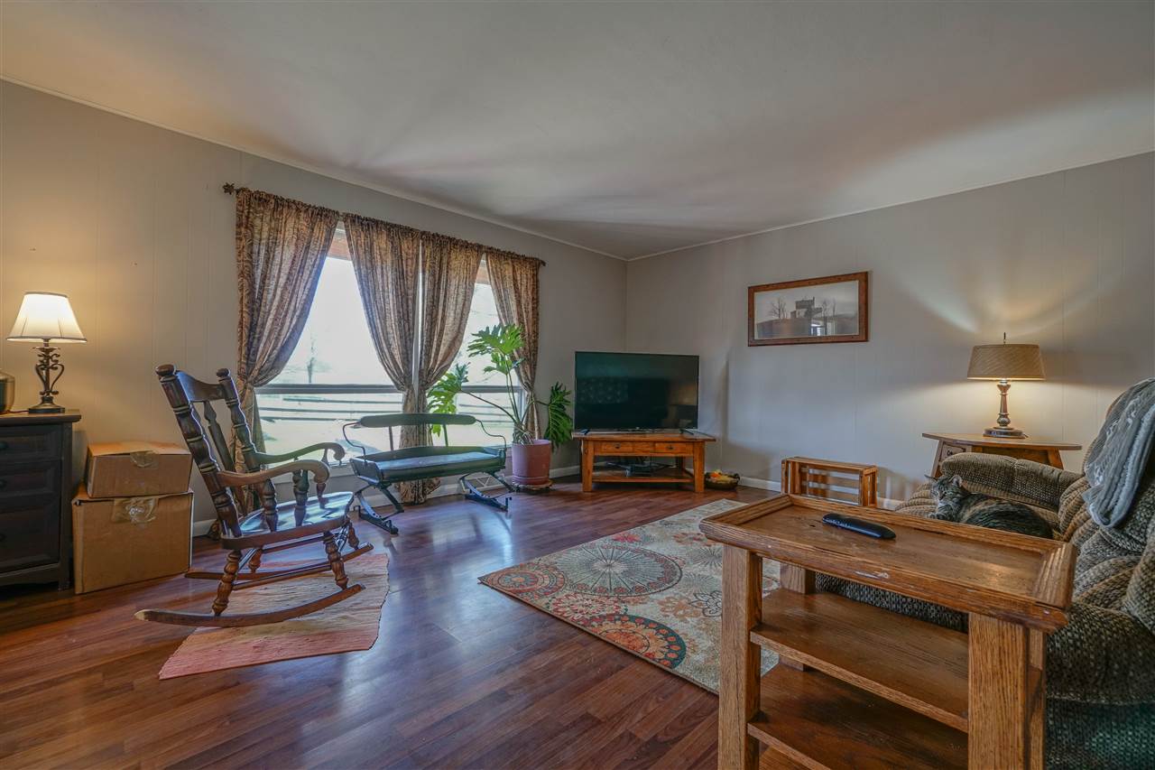 14588 Freeport Road Durand, IL 61024 - Photo 9 of 25 a living room with furniture a flat screen tv and a large window