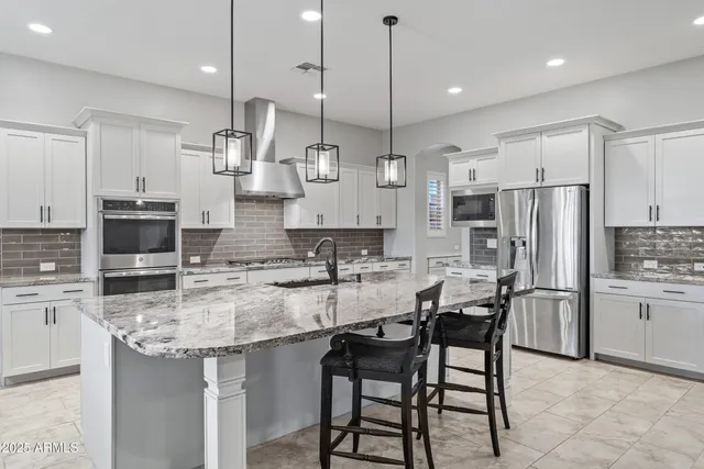 a view of a hallway with wooden floor and a bathroom