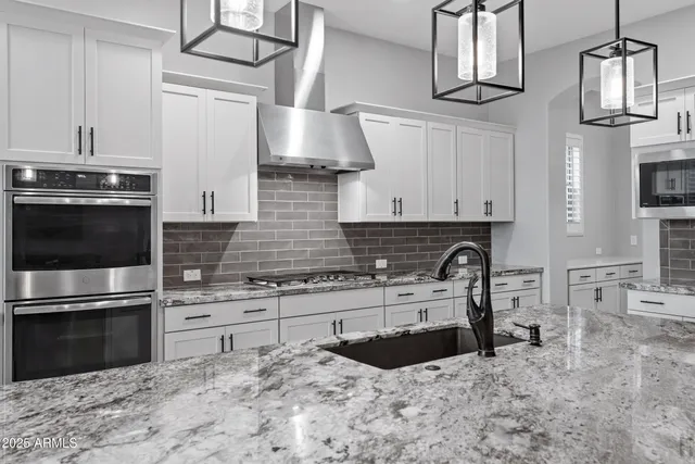 a view of a hallway with wooden floor and a bathroom