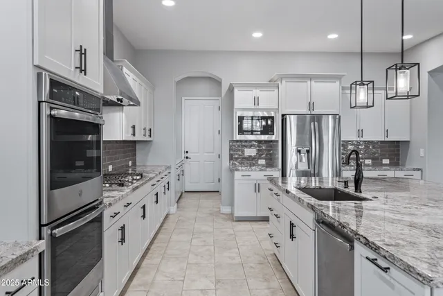 a bathroom with a granite countertop toilet sink and shower