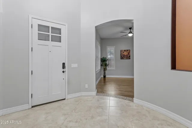 a bathroom with a granite countertop double vanity sink and a mirror