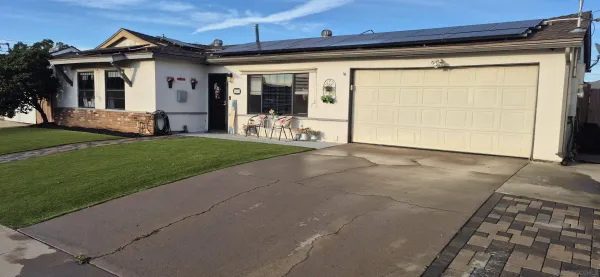 a view of a house with a yard and garage