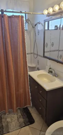 a bathroom with a sink vanity and a mirror